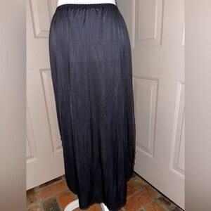 Vintage black nylon half slip with lace trim rounded hem & high side slits.